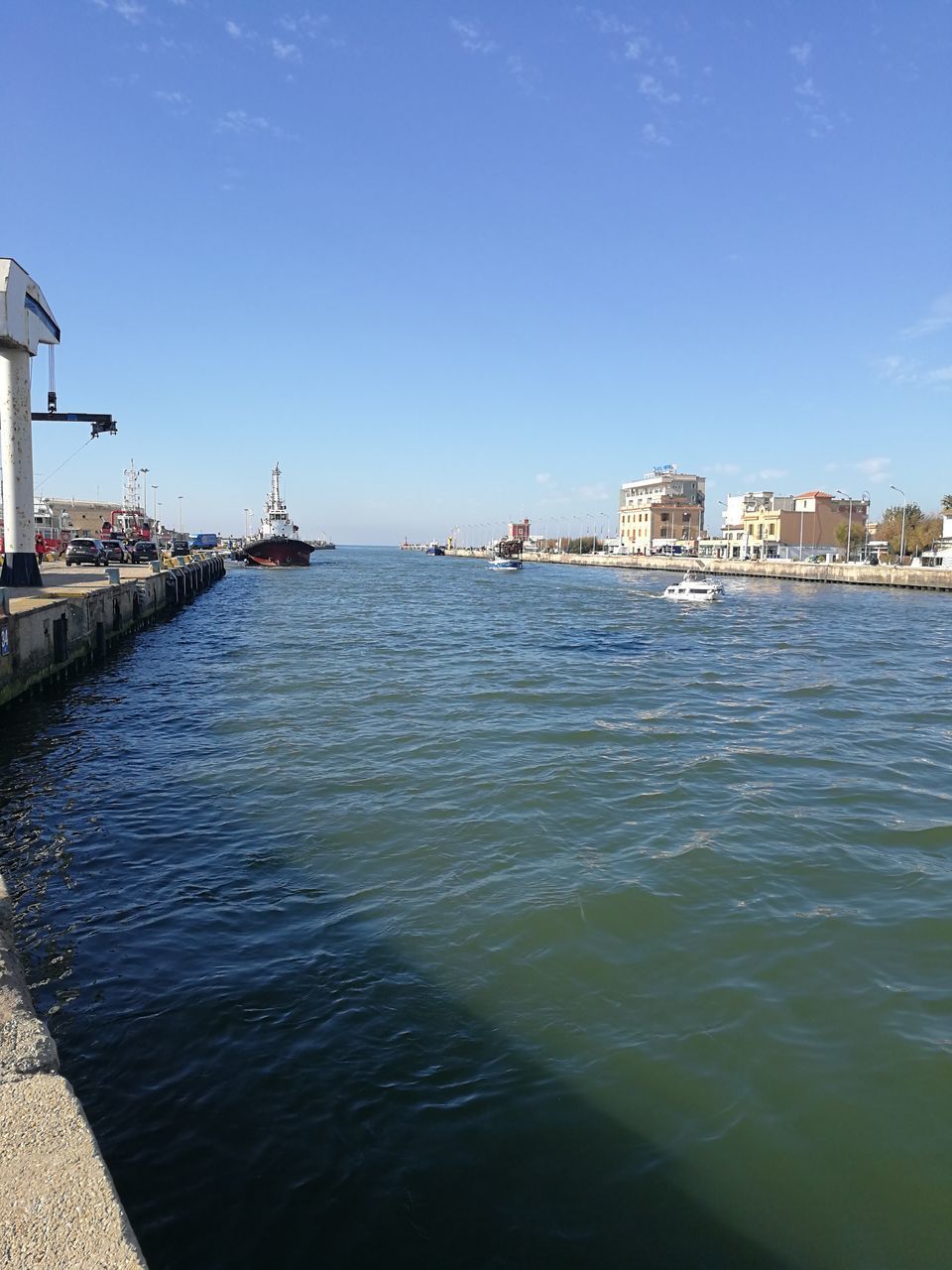 SCENIC VIEW OF SEA AGAINST BUILDINGS IN CITY