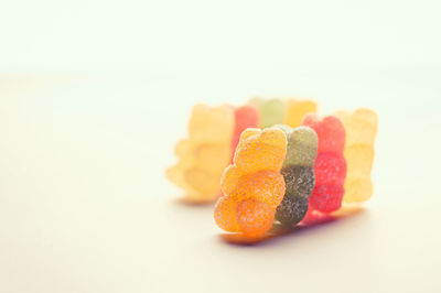 High angle view of gummy bear candy against white background