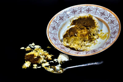 Close-up of food in bowl against black background
