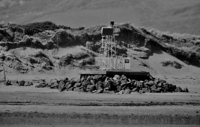 Built structure by sea against sky