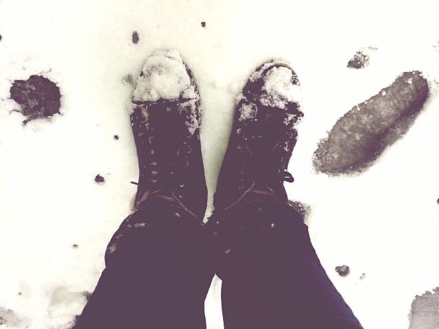 cold temperature, winter, snow, season, lifestyles, high angle view, frozen, leisure activity, white color, weather, standing, unrecognizable person, covering, shoe, personal perspective, men, person