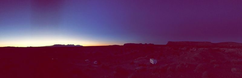 Scenic view of mountains against clear sky at sunset