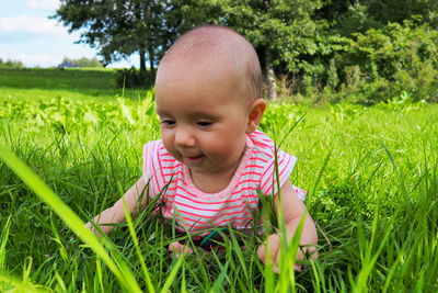 Portrait of cute smiling girl on field
