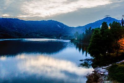 Scenic view of lake and mountains against sky