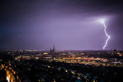 Panoramic view of illuminated city against sky at night