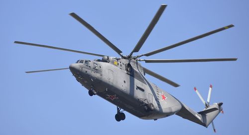 Low angle view of helicopter against clear blue sky