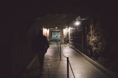 Rear view of man walking in tunnel at hoover dam