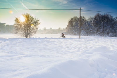 Scenic view of snow covered field against sky