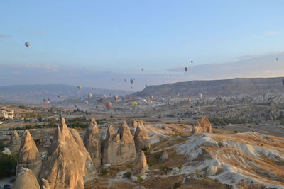 View of hot air balloon flying over landscape