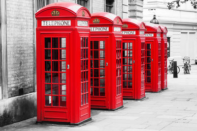 Red telephone booth in city