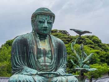 Statue of buddha against sky