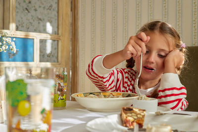 Portrait of smiling woman having food at home