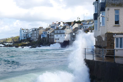 Panoramic shot of sea against buildings