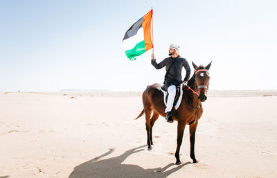 Man with horse on desert