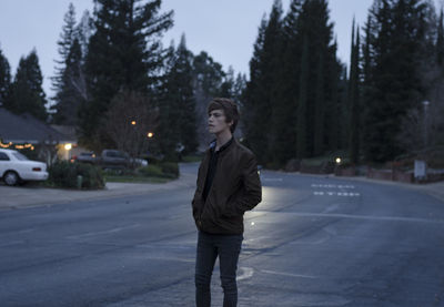 Portrait of a young man on road