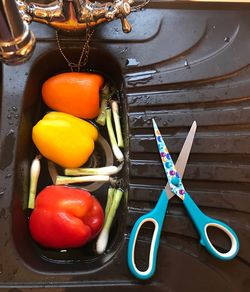 High angle view of vegetables and scissors