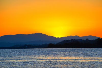 Scenic view of sea against orange sky