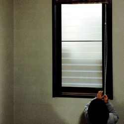 Woman looking through window