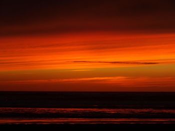 Scenic view of sea against romantic sky at sunset