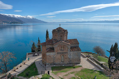 Historic building by mountain against sky