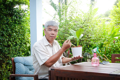 Portrait of man sitting on table