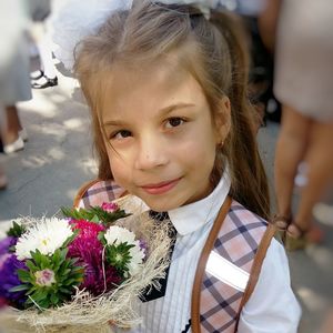 Portrait of smiling girl holding bouquet