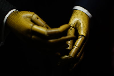 Close-up of mannequin against black background