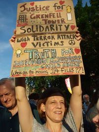 Low section of woman with text against sky