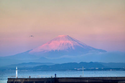 Scenic view of snowcapped mountains against sky during sunrise