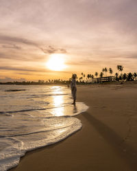 Scenic view of beach against sky during sunset