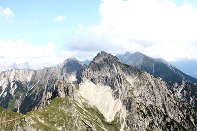 Scenic view of mountains against cloudy sky