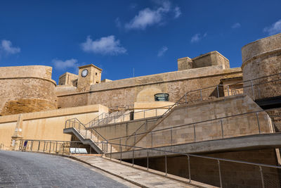 Low angle view of historical building against blue sky