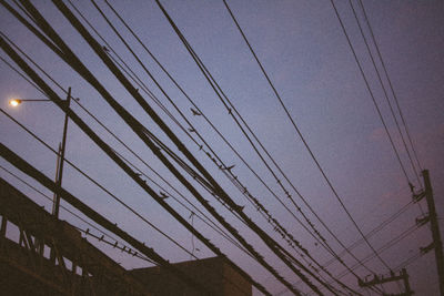 Low angle view of cables against sky