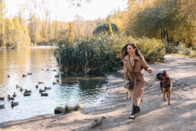 Full length of woman with dog in water