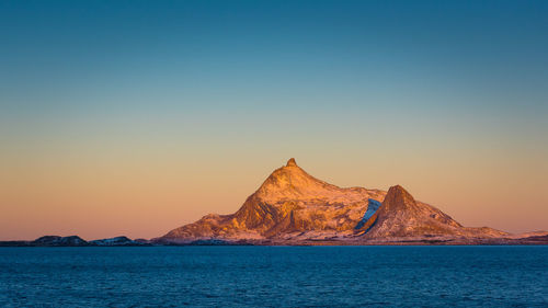 Scenic view of sea against clear sky during sunset