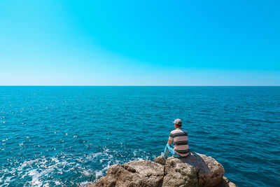 Scenic view of sea against clear blue sky