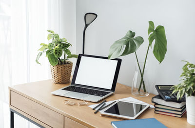 Office workplace with laptop on wooden table