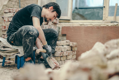 Side view of man working at workshop