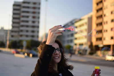 Young woman playing with bubbles