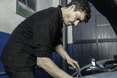 Side view of man working at construction site