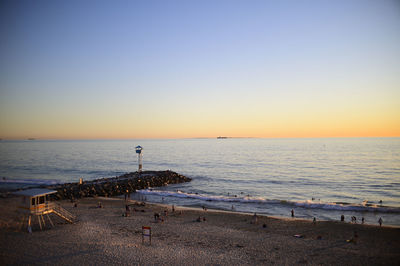 Scenic view of sea at city beach, perth, against clear sky during sunset
