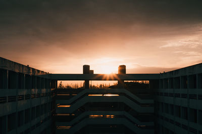 Silhouette buildings against sky during sunset