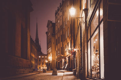 Street amidst buildings at night