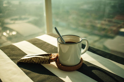 Set of morning coffee and snacks bar in warm morning sun.