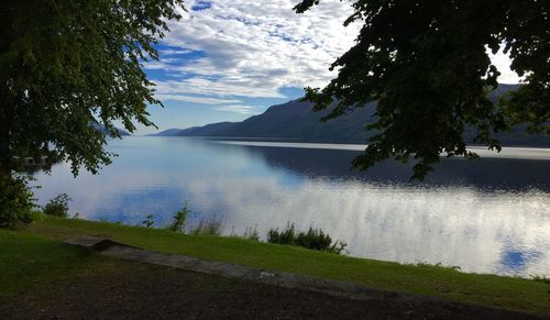 Scenic view of calm lake with mountains in background