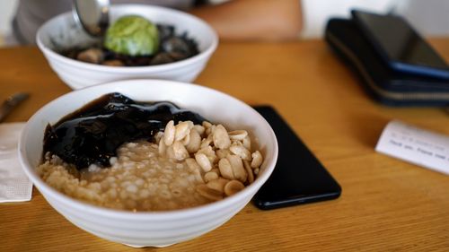 High angle view of breakfast in bowls on wooden table