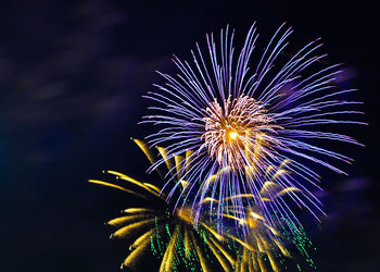 Low angle view of firework display at night