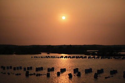 Scenic view of lake against orange sky
