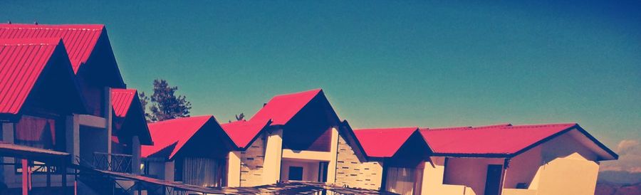 Low angle view of buildings against clear blue sky