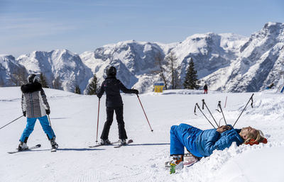 People skiing on snowcapped mountain